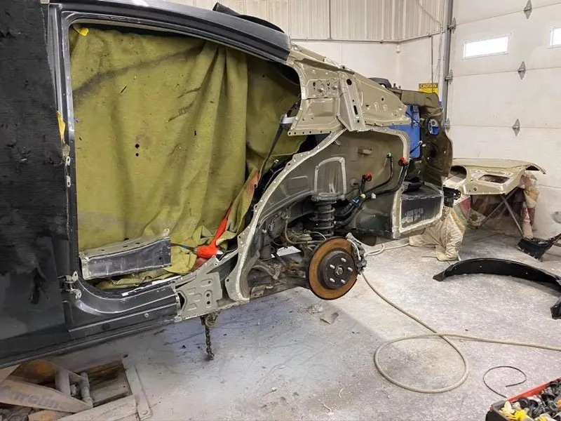 Damaged quarter panel and wheelhouse removed for repair
